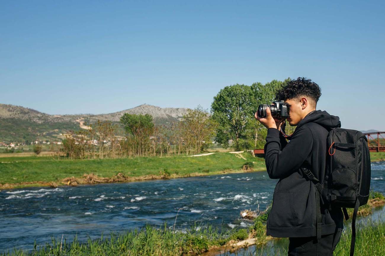 Person talking a photograph of a river